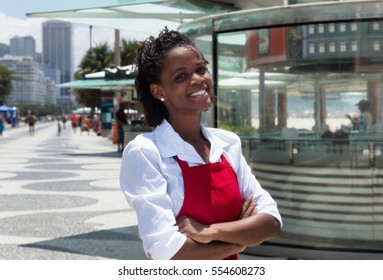 Laughing african american waitress in front of the restaurant - Powered by Shutterstock