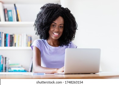 Laughing African American Woman Working At Computer In Quarantine Indoors At Home