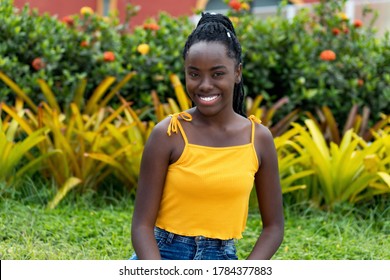 Laughing African American Young Adult Woman With Dreadlocks Outdoor At Park In Summer