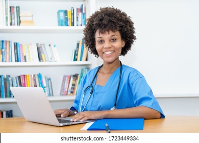 Laughing Afro American Nurse Or Medical Student At Computer At Hospital