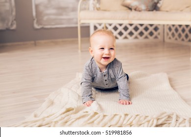 Laughing Baby Boy Lying On Tummy At Home