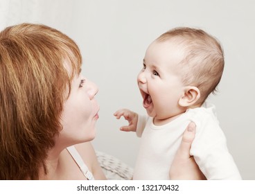 Laughing baby boy with mother