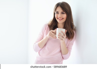 Laughing Beautiful Woman With Cup Of Coffee On White Background. Copy Space