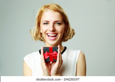 Laughing Beautiful Young Woman Holding Jewelery Gift Box