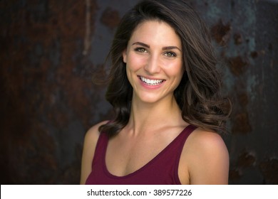 Laughing big white smile perfect straight teeth dental patient headshot female youthful genuine