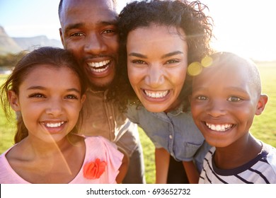 Laughing Black Family Outdoors, Close Up, Back Lit Portrait