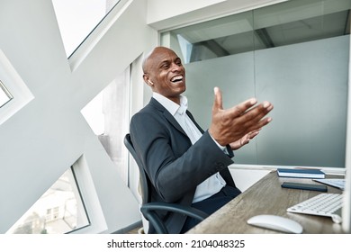 Laughing Black Male Businessman Watching On Computer During Working In Office. Adult Company Leader Wearing Wireless Earphones. Concept Of Modern Successful Man. Business Leadership And Management