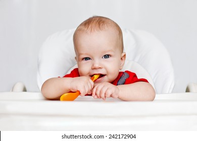 Laughing Boy Holding A Spoon On A White Background