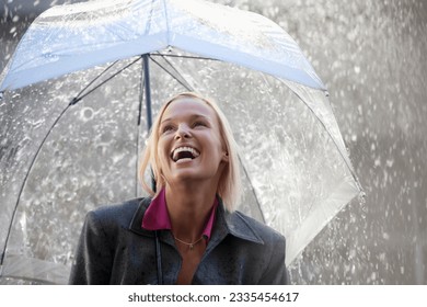 Laughing businesswoman under umbrella in rain - Powered by Shutterstock