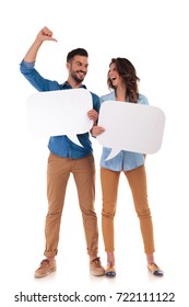 Laughing Casual Couple Holding Speech Bubbles , Man Is Pointing To His Woman On White Background