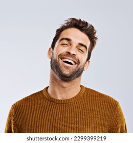 Laughing, comedy and portrait of happy man by white background. Smile, confident and face laugh of comic person, isolated and young male model enjoying a comedy joke on a studio backdrop - Powered by Shutterstock