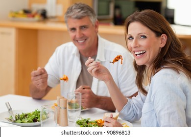 Laughing Couple Eating Dinner Together