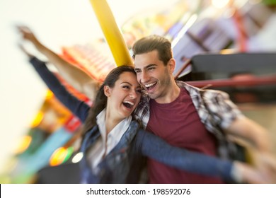 Laughing couple enjoy in riding ferris wheel- shoot with lensbaby