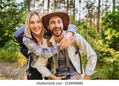 Laughing Couple Hiking In The Woods Posing For A Photo