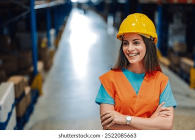 A laughing female warehouse worker, in a yellow hard hat and orange safety vest, enjoys a light-hearted moment in the midst of a busy industrial setting. Copy space. - Powered by Shutterstock