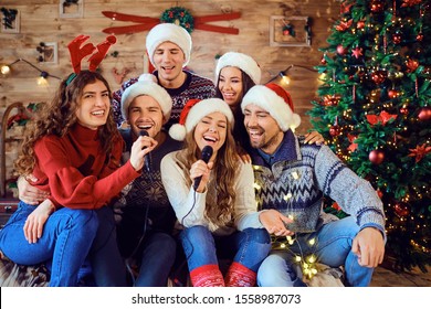 Laughing Friends Celebrating Christmas In Karaoke