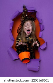 Laughing Funny Child Girl In A Witch Costume In Halloween