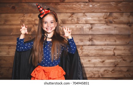 Laughing Funny Child Girl In A Witch Costume In Halloween
