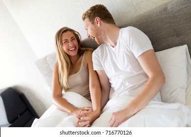 Laughing And Giggling Couple In Bed