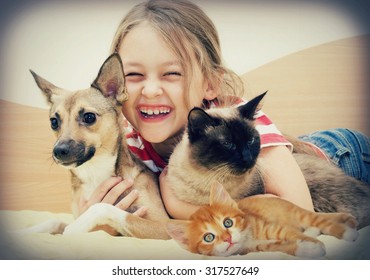 laughing girl and pets - Shutterstock ID 317527649