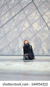 Laughing Girl Sitting Near The Louvre Pyramid