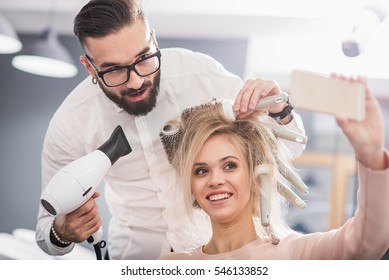 Laughing girl is taking picture with a stylist