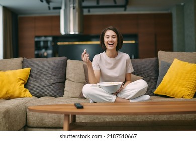 Laughing Girl Watching Stand Up Comedy, Comedian Show, Sitting With Popcorn Before Television On Sofa, Rests At Home