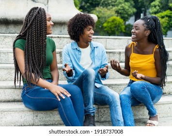 Laughing Group Of African American Female And Male Young Adults Outdoor In Summer In City