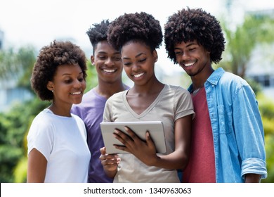 Laughing Group Of African American Students With Digital Tablet Outdoor In The Summer