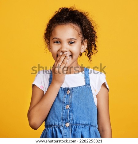 Laughing, happy and portrait of a child in a studio with a comic funny joke and positive mindset. Happiness, smile and face of a girl kid model giggling for comedy while isolated by yellow background Сток-фото © 