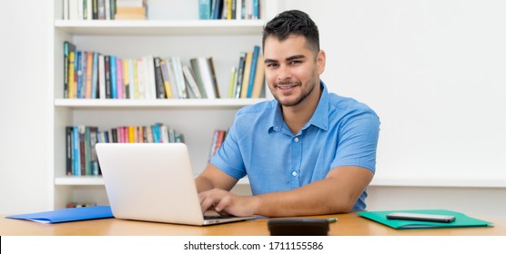 Laughing Hispanic Software Developer Stay At Home And Work With Concentration At Computer At Home