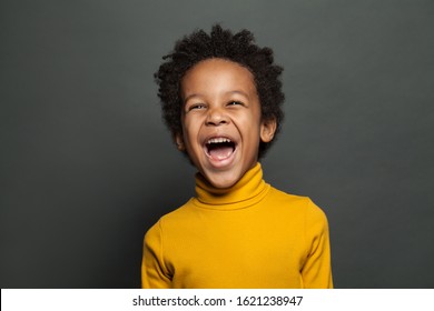 Laughing kid on gray background - Powered by Shutterstock