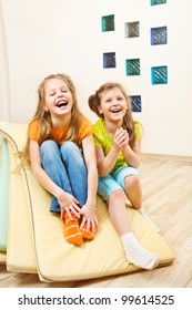 Laughing Little Girls Sit On Tumbling Mats