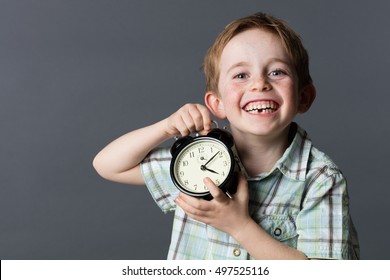 Laughing Little Kid With Freckles And Missing Tooth Holding A Clock For Time Concept And Youth With Happiness, Grey Background