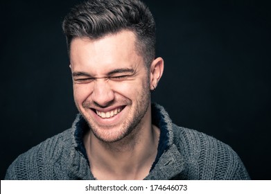 Laughing Man Close Up Portrait Against Dark Background. 