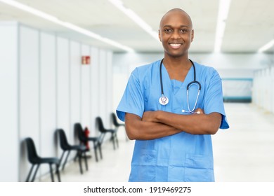 Laughing mature adult african american male nurse at vaccination station for vacinating patients against coronavirus infection