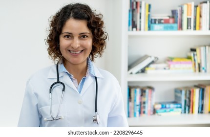 Laughing Mature Adult Doctor With Copy Space Indoors At Office