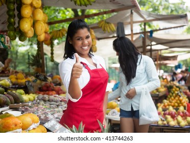 Laughing Mexican Saleswoman Showing Thumb Up On A Farmers Market In Latin America