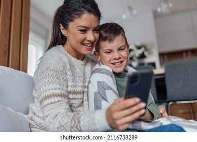 Laughing Mother And Son, Looking Through The Family Photo Gallery.