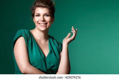 Laughing plump girl in a beautiful evening dress with neckline and natural makeup