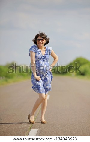laughing pregnant girl on road