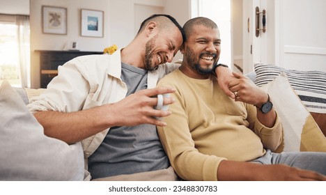 Laughing, relax and a gay couple on the sofa with coffee, conversation or love in a house. Happy, together and lgbt men on the living room couch for a funny story, communication or speaking with tea