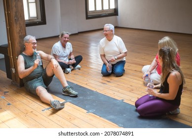 Laughing Seniors Taking Break After Dance Class. Relaxed Group Of Pensioners Resting After Dance Lesson. Dance, Hobby, Healthy Lifestyle Concept