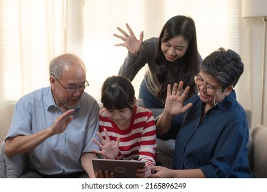 Laughing And Smiling Family Enjoying Social Media With Computer Tablet.