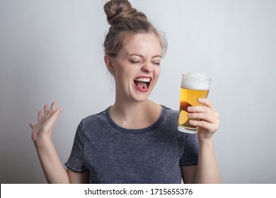 Laughing smiling young caucasian woman girl with glass of beer - Powered by Shutterstock