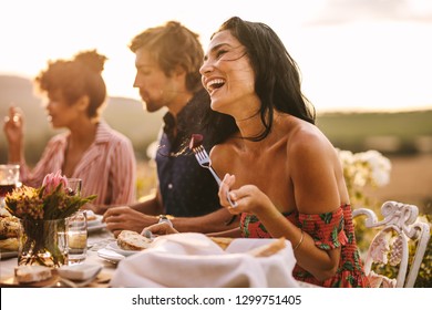 Laughing Talking With Friends While Having Food At A Party Outdoors. Woman Enjoying With Friends At A Dinner Party.