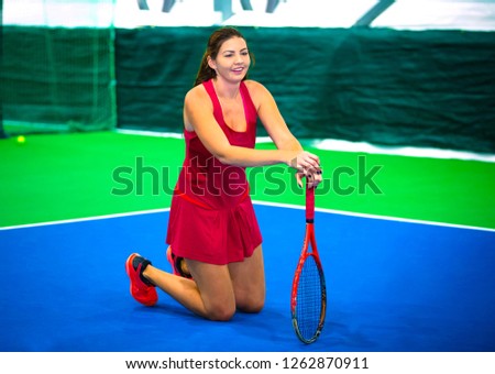 Laughing tennis girl on her knees on court, positive concept