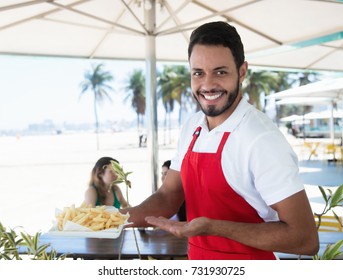 Laughing Waiter Serving French Fries At Beach Bar