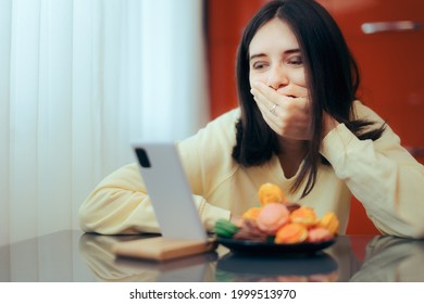 
Laughing Woman Binge Watching A Video Or Making A Video Conference Call. Person Being Entertained At Home Eating And Streaming A Comedy Show
