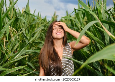 Laughing Woman Fixing Hair In The Corn Field